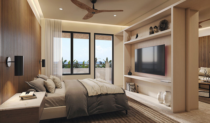 Amplia recámara de lujo con vista al mar en el condominio Nalu Luxury Beachfront Residences. Cuenta con cama king-size, TV de pantalla plana, amplio armario y baño privado con bañera y ducha.