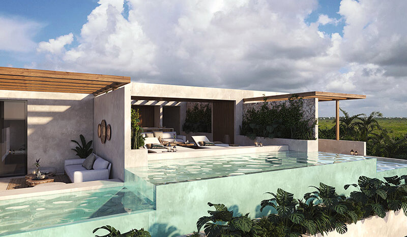Roof garden en el Condominio Nalu Luxury Beachfront Residences con vista al mar, área verde y mobiliario de exterior.